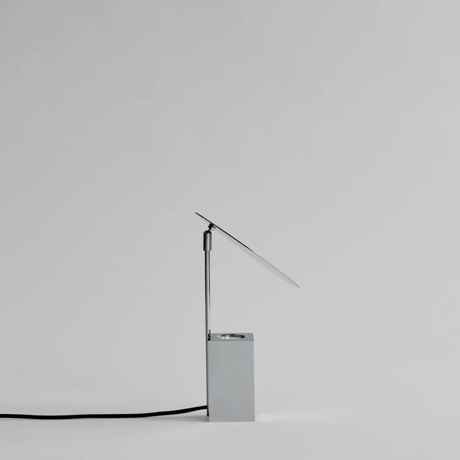Modern table lamp with a minimalist design on a light gray background