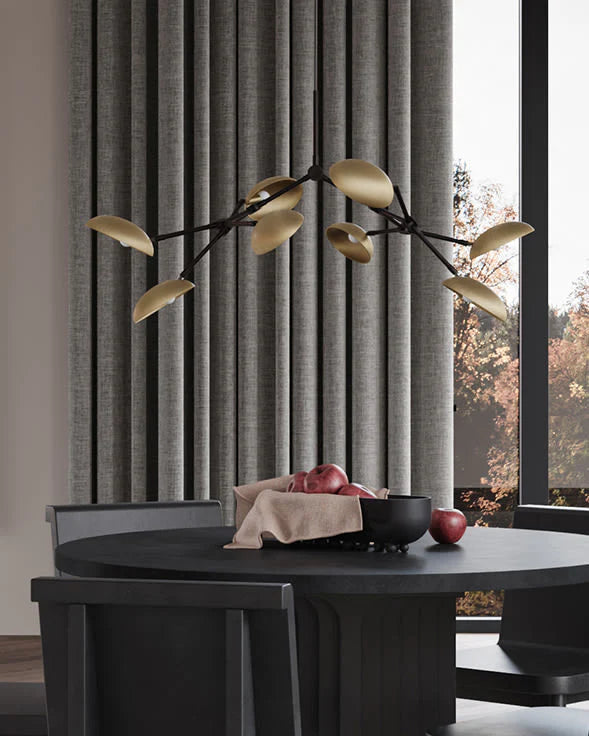 Modern dining room with a black table, gray curtains, and decorative lighting fixture.
