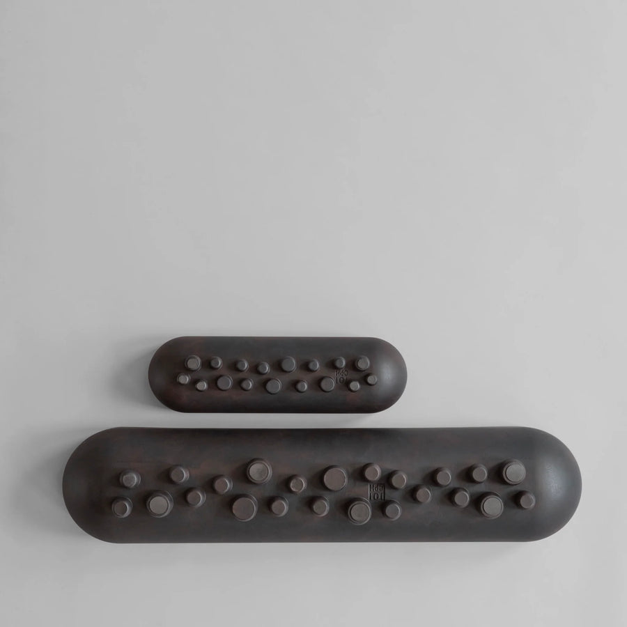 Two coffee colour Shinju platters with textured ends on a light gray background from 101 Copenhagen at Spacio retail stores in Mumbai & Kolkata. 