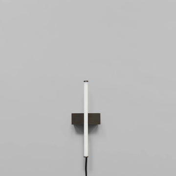 Stick Wall Light Bronze by 101 Copenhagen on a light grey background available at Spacio retail stores in Mumbai & Kolkata. 
