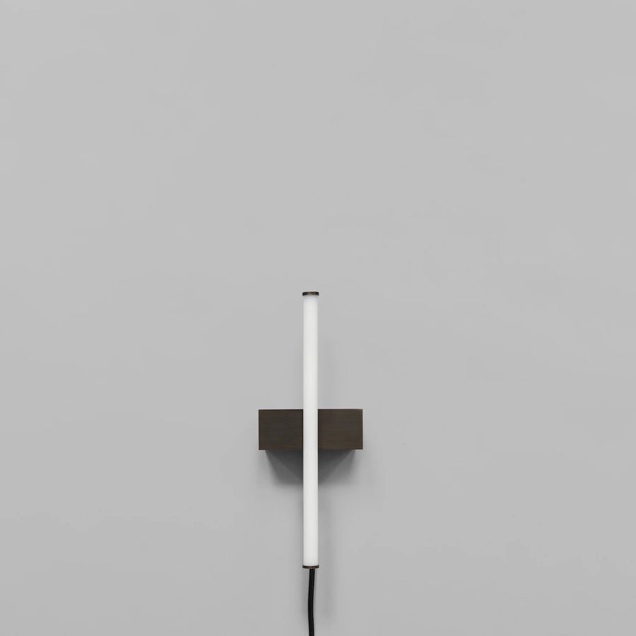 Stick Wall Light Bronze by 101 Copenhagen on a light grey background available at Spacio retail stores in Mumbai & Kolkata. 