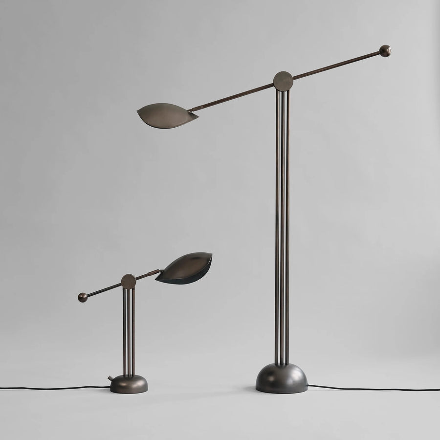 Modern floor lamp with adjustable arms on a gray background