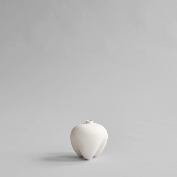 White ceramic vase on a light gray background from 101 Copenhagen at Spacio retail stores in Mumbai & Kolkata. 