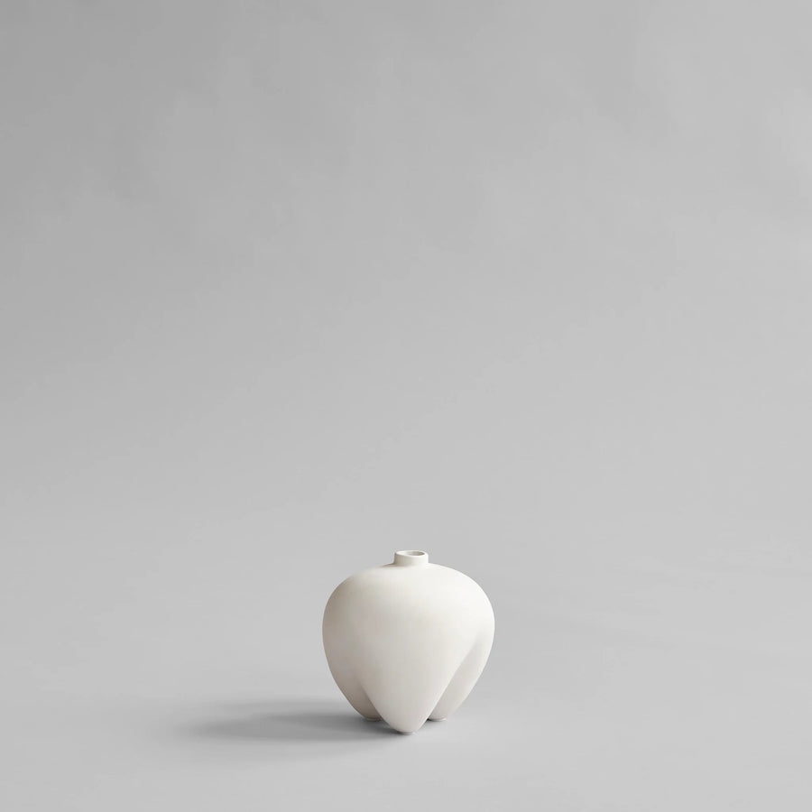 White ceramic vase on a light gray background from 101 Copenhagen at Spacio retail stores in Mumbai & Kolkata. 