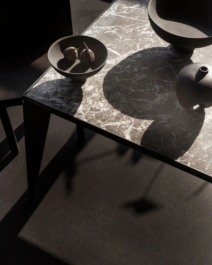 Dark marble table with decorative items from 101 Copenhagen at Spacio retail stores in Mumbai & Kolkata. 