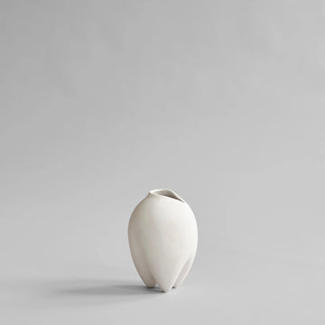 White ceramic vase on a light gray background from 101 Copenhagen at Spacio retail stores in Mumbai & Kolkata. 