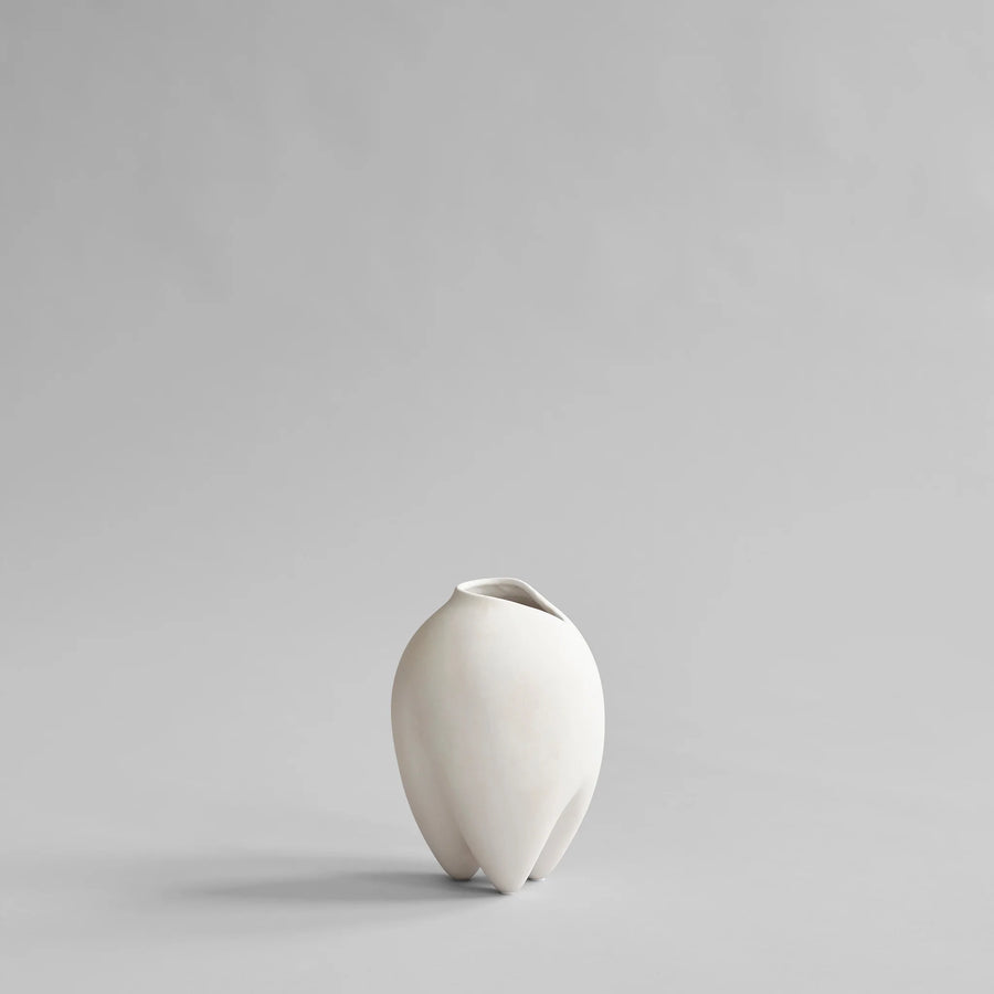 White ceramic vase on a light gray background from 101 Copenhagen at Spacio retail stores in Mumbai & Kolkata. 