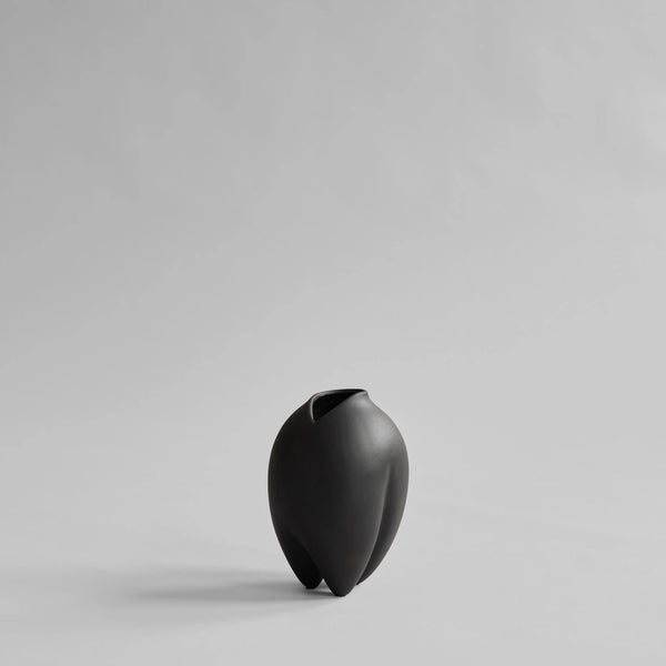 Black vase on a light gray background from 101 Copenhagen at Spacio retail stores in Mumbai & Kolkata. 