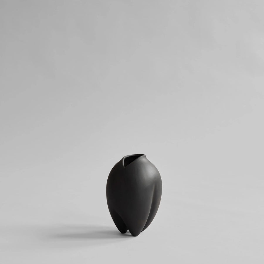 Black vase on a light gray background from 101 Copenhagen at Spacio retail stores in Mumbai & Kolkata. 