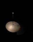 Light fixture with a cloud-like design on a black background
