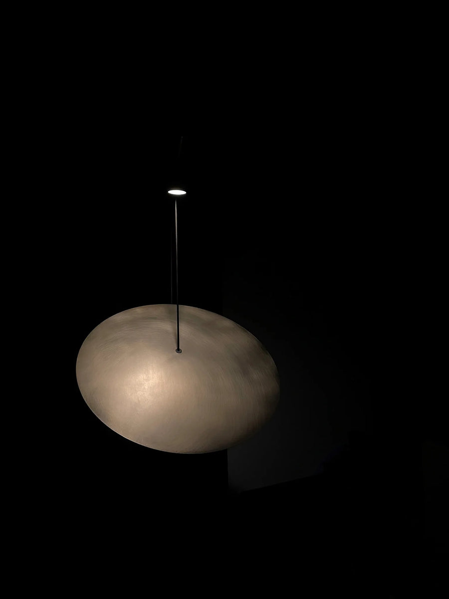 Light fixture with a cloud-like design on a black background
