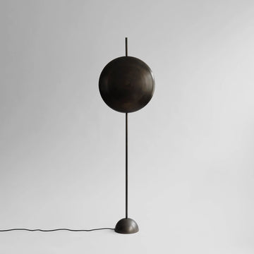 Modern floor lamp with a spherical design on a plain background