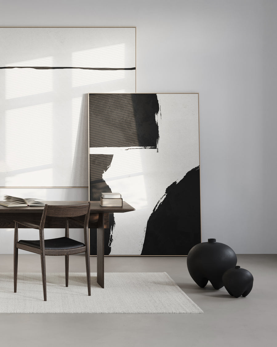 Modern interior with abstract art, a desk, and black vases from 101 Copenhagen at Spacio retail stores in Mumbai & Kolkata. 