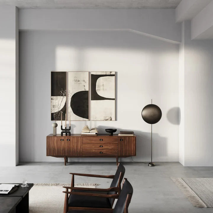 A modern living room with white walls and wooden furniture featuring the 101Cph Empire Mini Dark Grey 223036 color and ceramic accents by 101 Copenhagen.