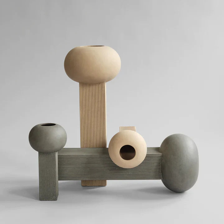 A set of three 101Cph Empire Mini Dark Grey 223036 wooden vases on a dark grey background. (Brand: 101 Copenhagen)