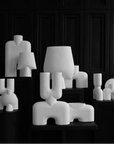 A black and white photo of a group of 101Cph Cobra Double Mini Bubble White 203022 sculptures in Copenhagen by 101 Copenhagen.