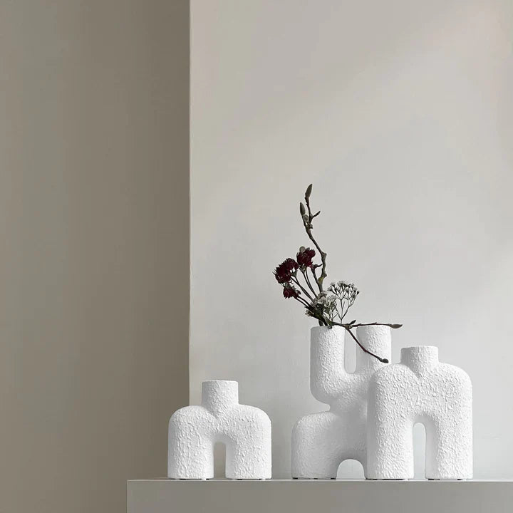 Three 101Cph Cobra Double Mini Bubble White 203022 vases, inspired by Copenhagen design, sit on a shelf in a room.