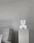 A grey couch with a 101Cph Cobra Double Mini Bubble White 203022 sculpture on top of it in Copenhagen.