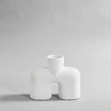 A 101Cph Cobra Uno Medio Bubble White 201012 vase on a grey background. The vase, from 101 Copenhagen's Cobra Uno Medio bubble collection, stands out in its pure white colour against the muted grey backdrop.