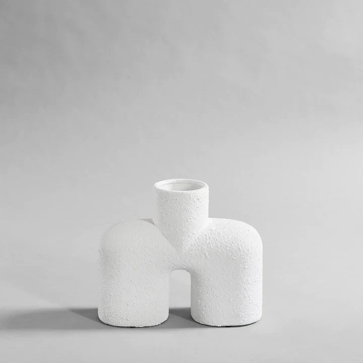 A 101Cph Cobra Uno Medio Bubble White 201012 vase on a grey background. The vase, from 101 Copenhagen's Cobra Uno Medio bubble collection, stands out in its pure white colour against the muted grey backdrop.