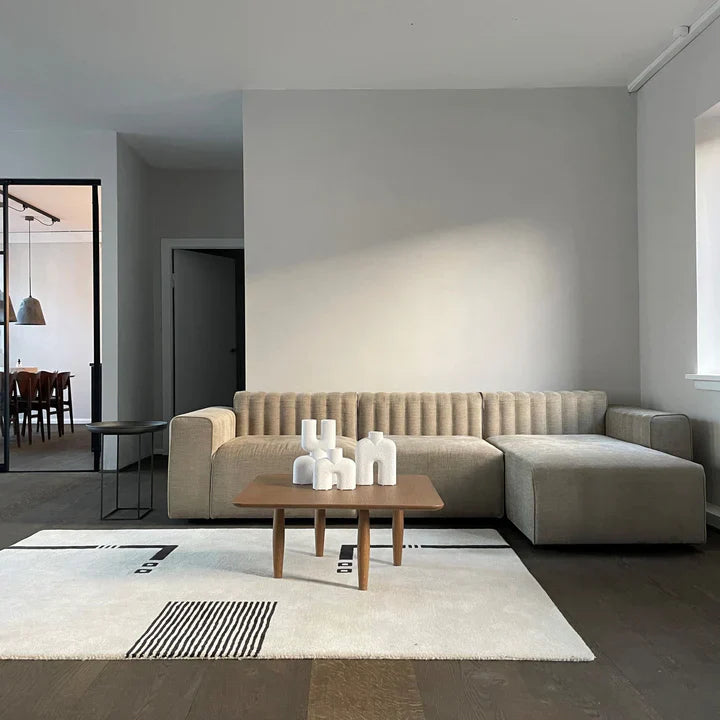 A living room with a beige couch and a coffee table featuring the 101Cph Cobra Uno Mini Bubble White 203021 by 101 Copenhagen.