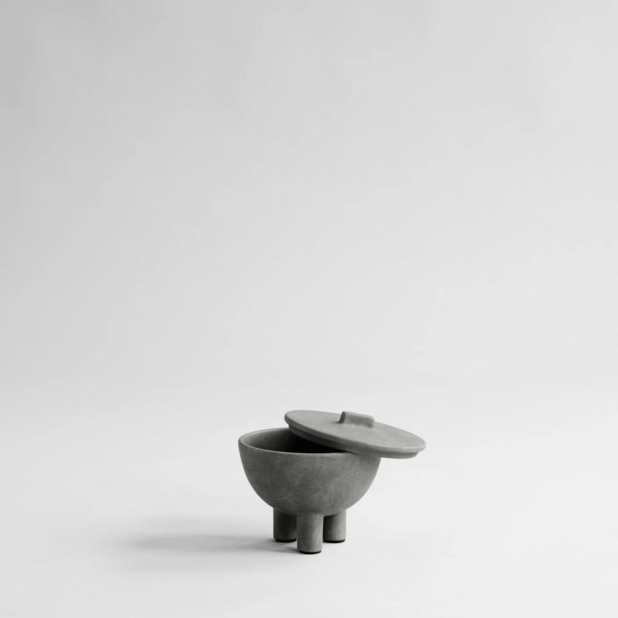 Gray ceramic bowl with lid on a light gray background from 101 Copenhagen at Spacio retail stores in Mumbai & Kolkata. 