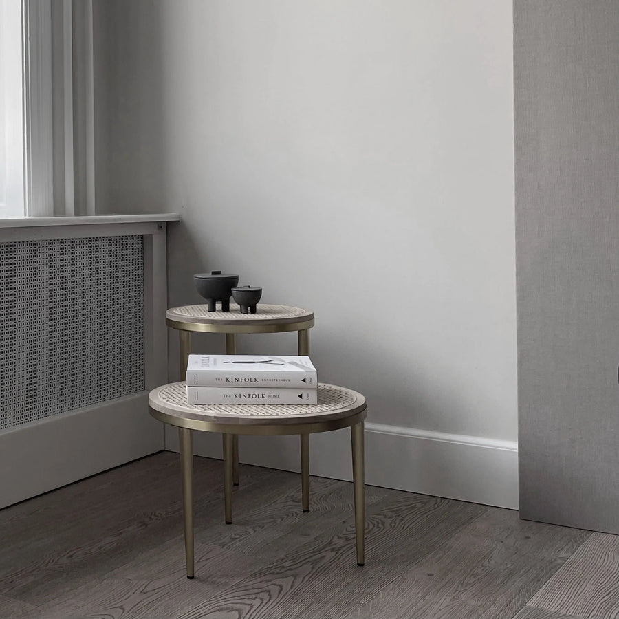 Two round side tables with books and small decorative items against a neutral wall from 101 Copenhagen at Spacio retail stores in Mumbai & Kolkata. 