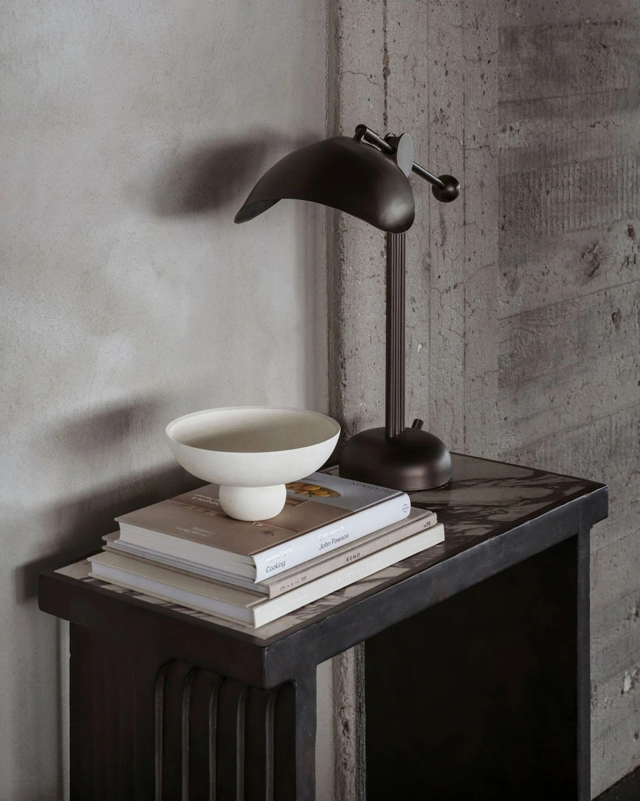 Bowl, coffee table books and a lamp styled on Fibre concrete and calacatta marble top console from 101 Copenhagen at Spacio retail stores in Mumbai & Kolkata. 