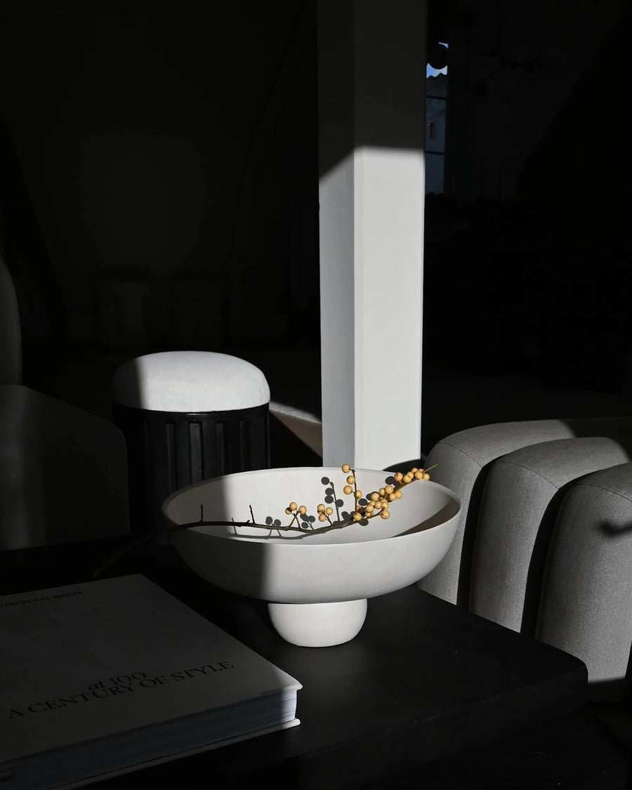 Modern white bowl with decorative elements on a dark surface from 101 Copenhagen at Spacio retail stores in Mumbai & Kolkata. 