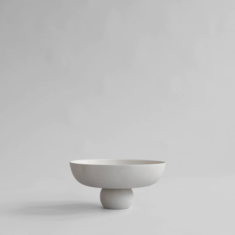 White ceramic bowl on a light gray background from 101 Copenhagen at Spacio retail stores in Mumbai & Kolkata. 