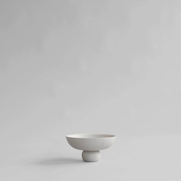 White ceramic bowl on a light gray background from 101 Copenhagen at Spacio retail stores in Mumbai & Kolkata. 
