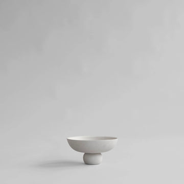 White ceramic bowl on a light gray background from 101 Copenhagen at Spacio retail stores in Mumbai & Kolkata. 