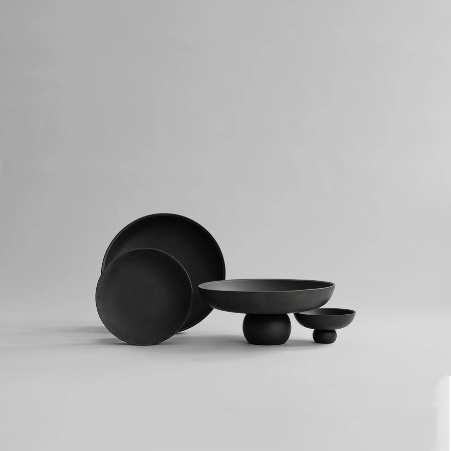 Set of black ceramic bowls on a light gray background from 101 Copenhagen at Spacio retail stores in Mumbai & Kolkata. 