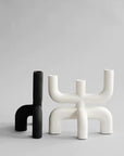 Two 101Cph Cobra Candle Holder Black 223071 adding minimalism to the interior styling on a grey surface.
