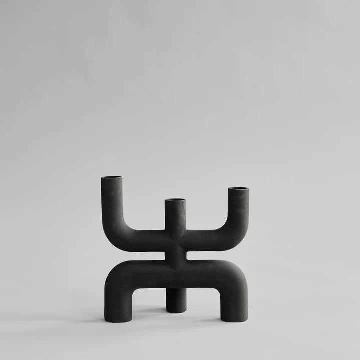A Nordic collection Cobra Candle Holder by 101 Copenhagen, styled for interior decor.