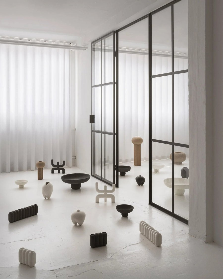 Modern interior with various ceramic and metal objects on a light floor from 101 Copenhagen at Spacio retail stores in Mumbai & Kolkata. 