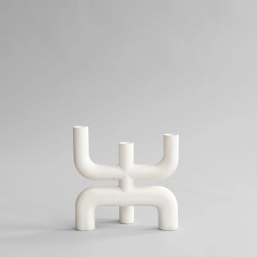 White abstract candle holder on a light gray background from 101 Copenhagen at Spacio retail stores in Mumbai & Kolkata. 