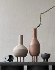 Three 101Cph Duck Vase Slim Terracotta 213044 vases on a table next to a wall. (Brand: 101 Copenhagen)