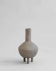 A small grey 101Cph Duck Vase Fat Taupe 213045 on a white background, featuring a quirky design inspired by the Copenhagen Duck Vase and the Cobra Arts Movement. Brand Name: 101 Copenhagen.