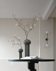 Two 101Cph Empire Big Dark Grey 223034 vases, ceramic architectural references, positioned on a table in a room.