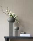 Two 101Cph Empire Big Dark Grey 223034 vases on a ceramic shelf, adorned with books and fresh flowers.