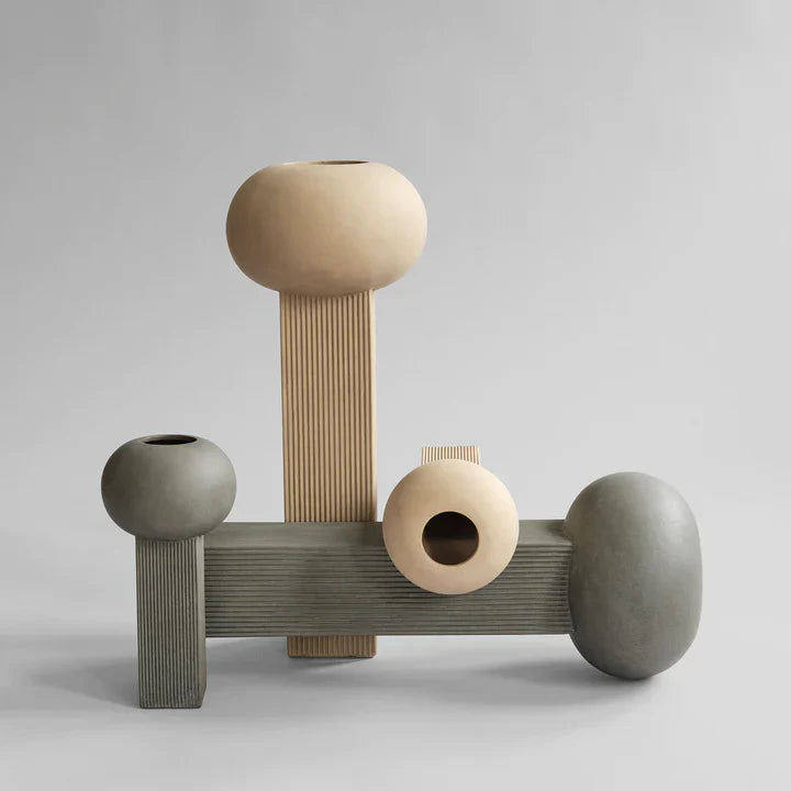A set of three 101Cph Empire Big Dark Grey 223034 Vases on a grey background, made by 101 Copenhagen.