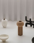 A group of quirky 101Cph Empire Mini Sand 223037 vases and bowls from the 101 Copenhagen Cobra Arts Movement displayed on a white table.