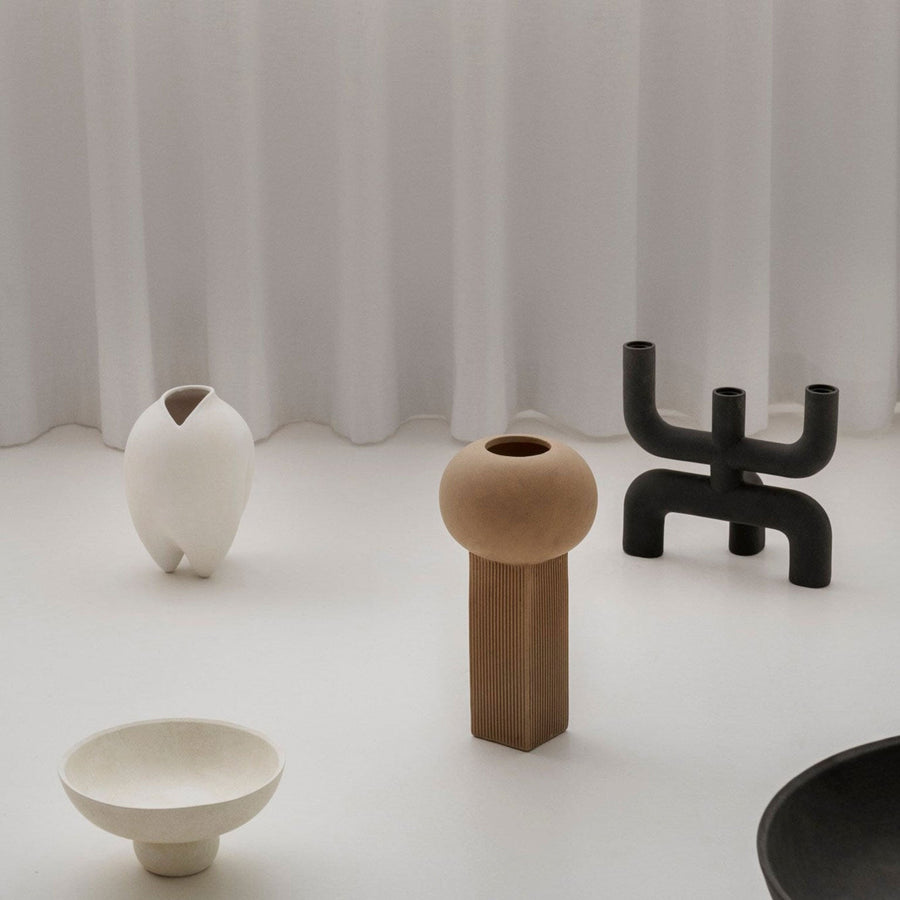 A group of quirky 101Cph Empire Mini Sand 223037 vases and bowls from the 101 Copenhagen Cobra Arts Movement displayed on a white table.