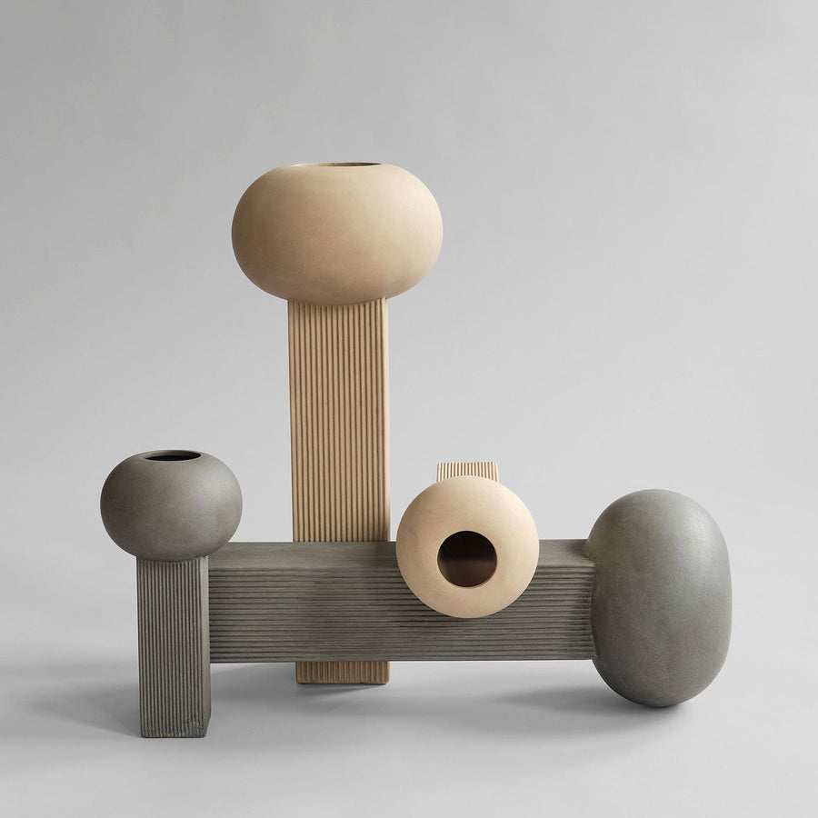 A set of three 101Cph Empire Mini Sand 223037 vases on a grey background, by 101 Copenhagen.