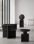 A modern living room with a 101Cph Guggenheim Big Black 203004 table from the brand 101 Copenhagen and quirky vases.