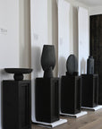 An interior setting featuring several 101Cph Guggenheim Big Black 203004 vases by 101 Copenhagen on display.