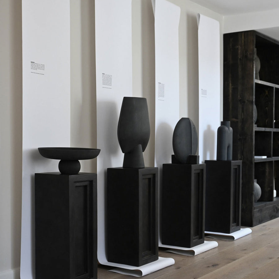 An interior setting featuring several 101Cph Guggenheim Big Black 203004 vases by 101 Copenhagen on display.