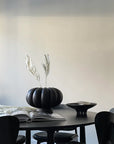 A 101Cph Medusa Tray Mini Coffee 221064 with black chairs and a ceramic pumpkin vase.
