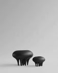 A pair of 101Cph Medusa Vase Mini Coffee 221062 ceramic stools by 101 Copenhagen on a white surface.